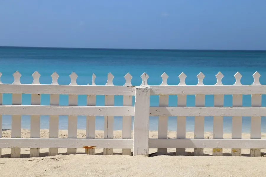A white picket fence on the beach