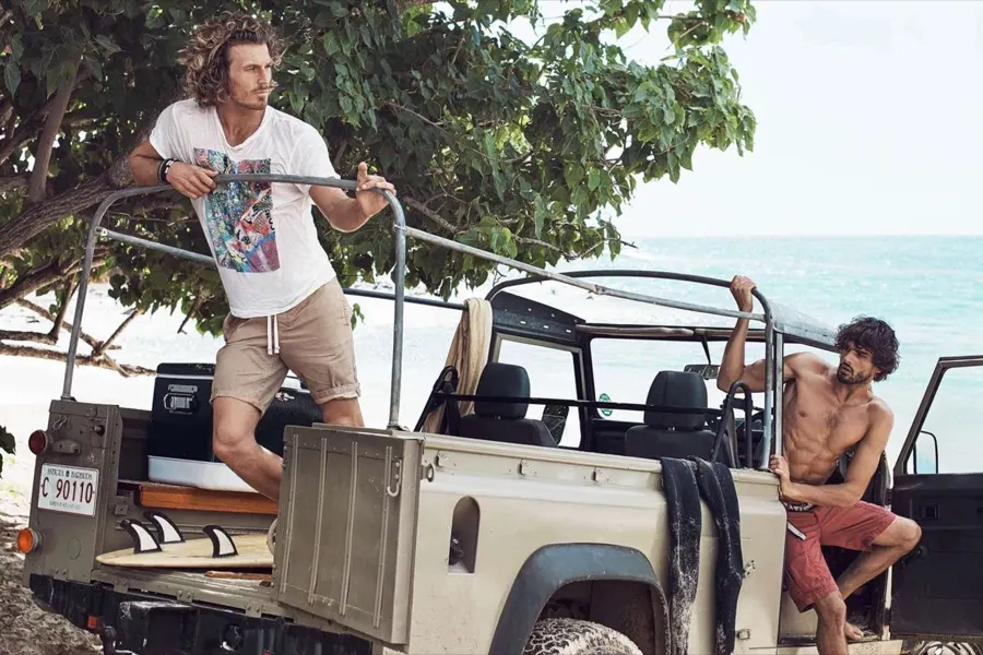 Models with a Land Rover on the beach