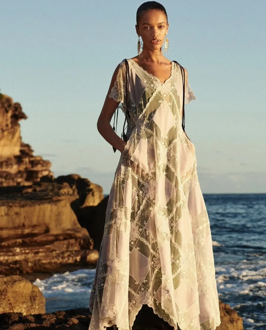 Model in a long dress against sandstone cliffs